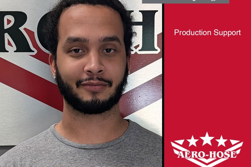 a man with a beard and a top bun stands in front of a red, white, and black background. text on the image reads "andrew springs, production support, aero-hose - auto draft.