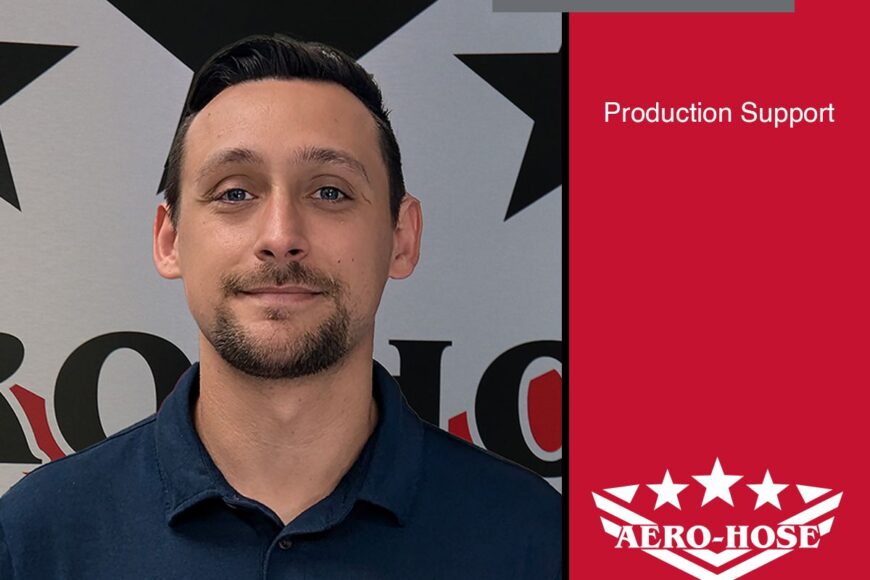 a man with short dark hair stands in front of a wall adorned with black stars and the aero-hose logo. the text reads "michael bernardi, production support, auto draft specialist.