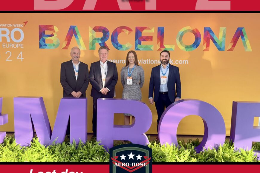 four people stand proudly before a vibrant "barcelona" and "#mro" display at the aviation expo, with the sign announcing, "last day to meet the team at mro europe, booth #6222. don't miss this opportunity to engage with experts and discuss your important automotive drafting needs.